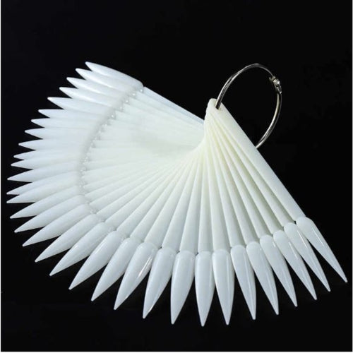 White stiletto nail-shaped earrings on a black background
