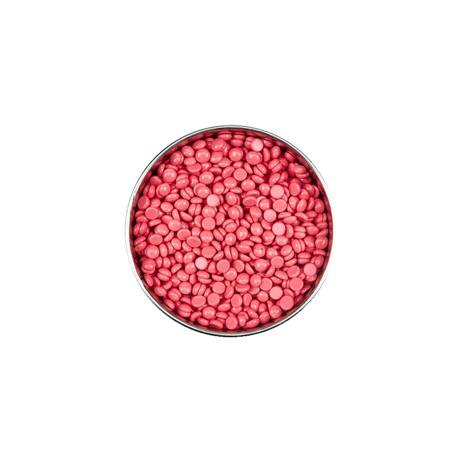 Pink round candies in a metal container on a white background