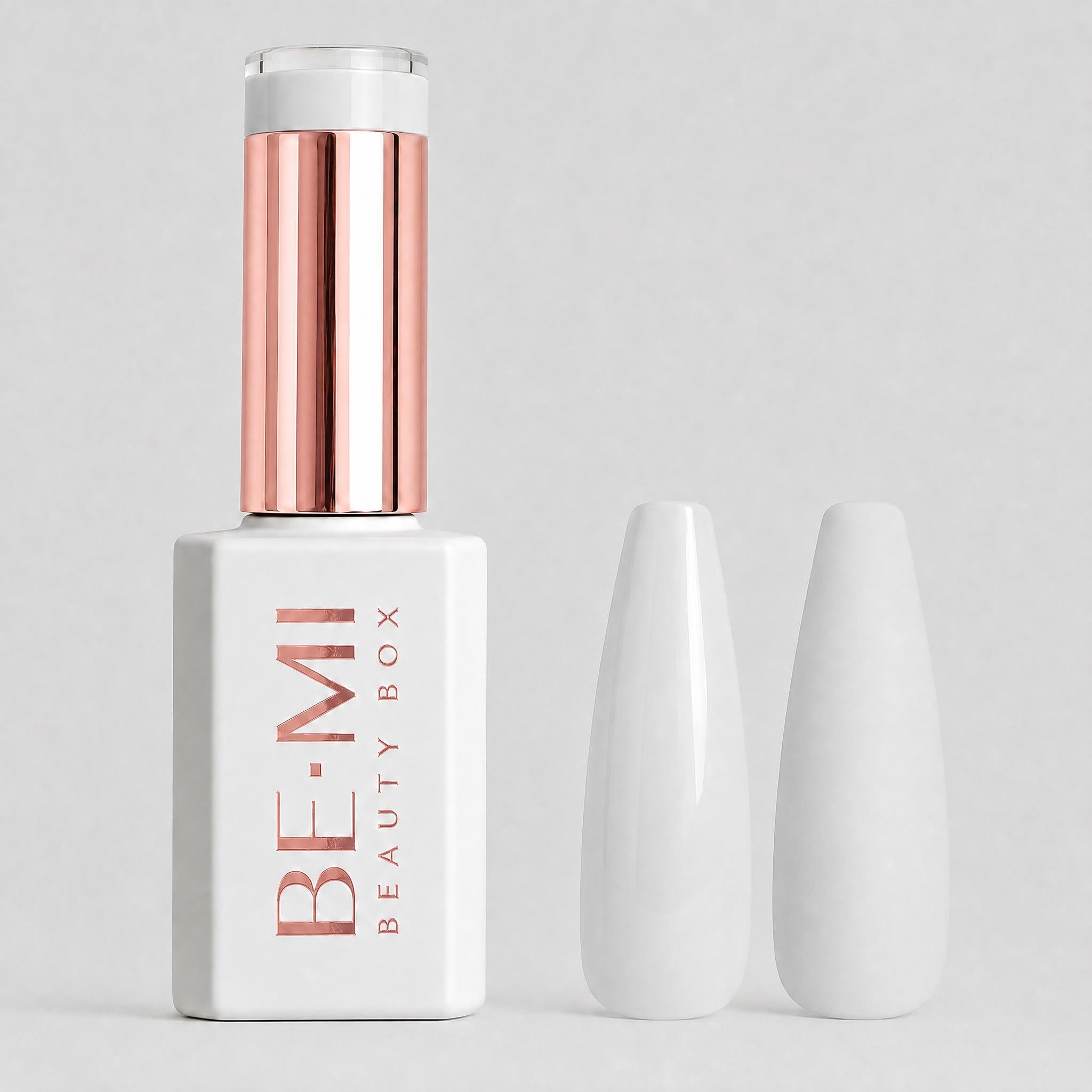 A bottle of BE-MI Beauty Box gel nail polish in a matte white shade, shown next to two glossy white artificial nail tips on a light gray background.