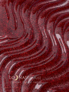 Red glittery gel with wavy patterns and 'LOUNA Stardust' branding.
