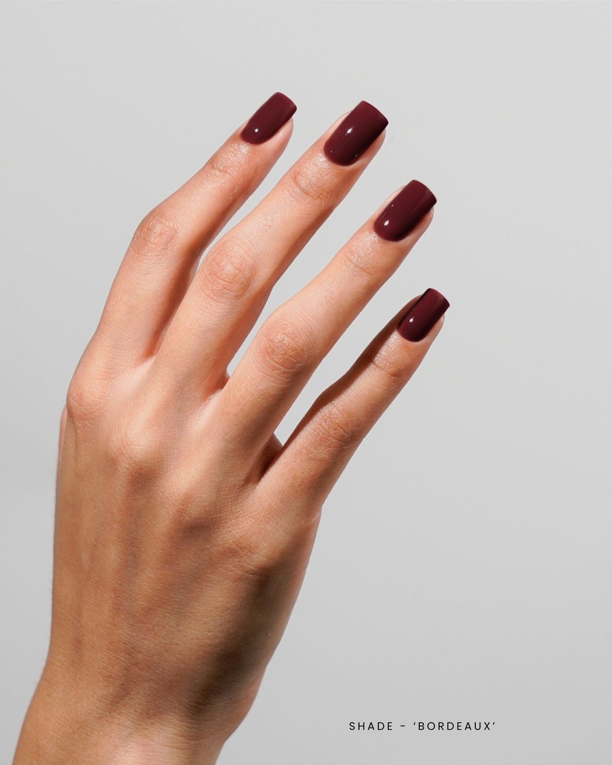 Akzentz Luxio Bordeaux gel polish shown on manicured nails