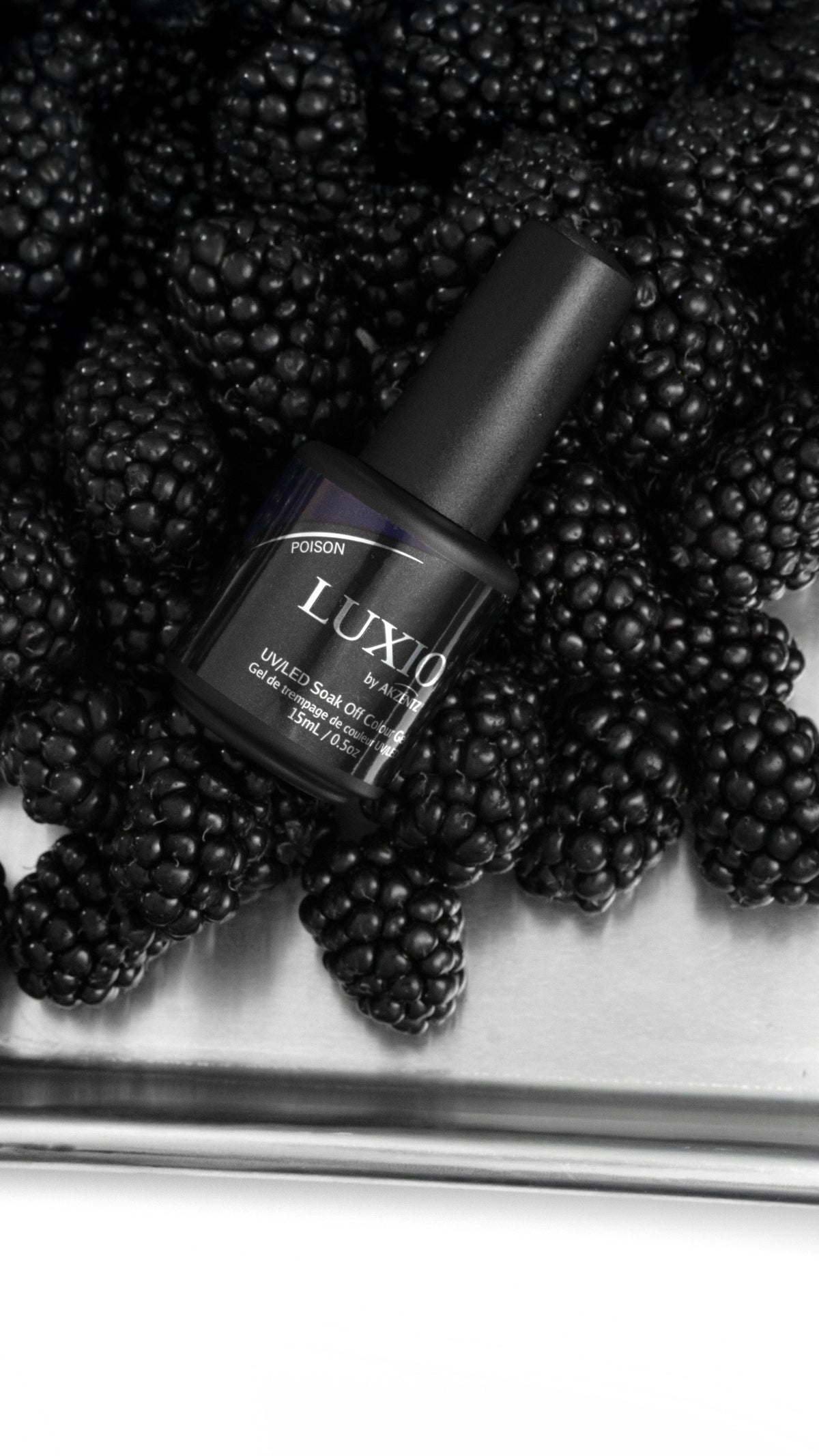 Akzentz Luxio Poison gel bottle among blackberries