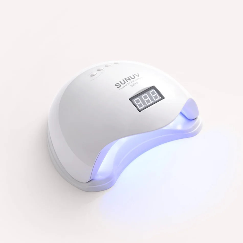 White nail dryer with digital display on a white background