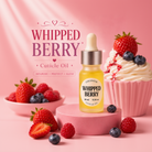Coconoir Whipped Berry cuticle oil with strawberries and blueberries on a pink background