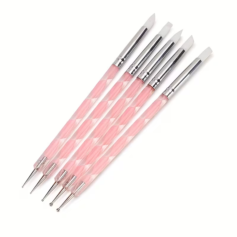 Set of pink nail art brushes with silver accents on a white background