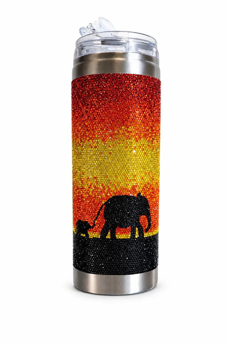 Tumbler with glittery sunset design and elephant silhouette on a white background
