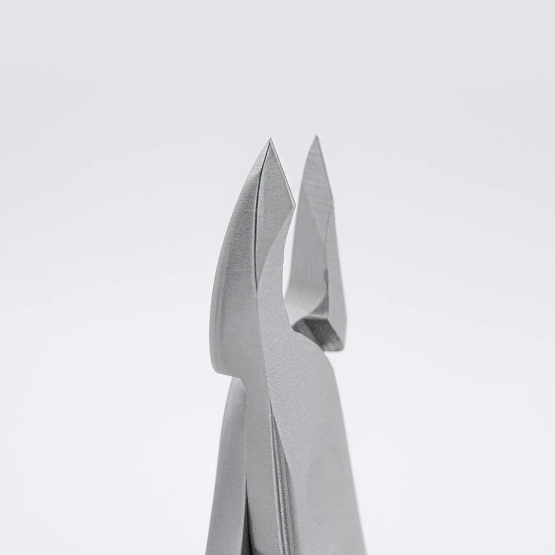 Close-up of metallic gray pliers or tweezers against a clean light gray background.